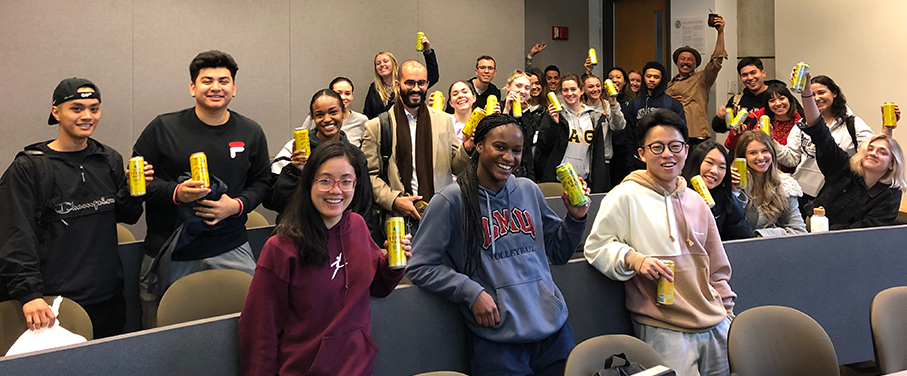 students holding cans of Guayaki beverages